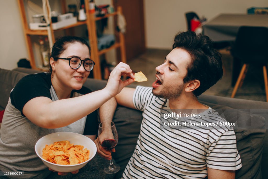 Young adult couple sharing a quiet night at home with snacks,Belo Horizonte,State of Minas Gerais,Brazil