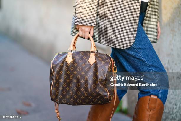 Gabriella Berdugo wears a Steelers cap hat, vintage mom denim blue jeans, a vintage checked print beige oversized blazer jacket, a "Speedy" brown...