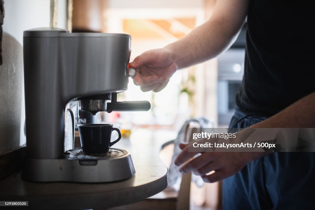 Midsection of man preparing coffee at home,Poland