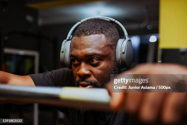 young man using headphones in the gym,temanggung,indonesia - junior gym stock pictures, royalty-free photos & images