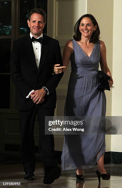 Secretary of the Treasury Timothy Geithner and his wife Carole arrive at a state dinner at the White House October 13, 2011 in Washington, DC....