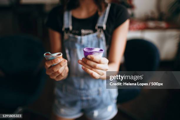 teenage girl holding two reusable menstrual cups,belo horizonte,state of minas gerais,brazil - menstrual cup stock pictures, royalty-free photos & images