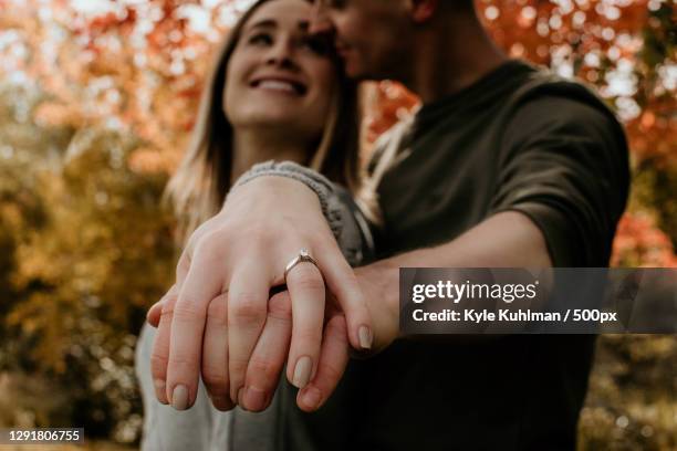 young couple in love showing off engagement ring,bar harbor,maine,united states,usa - engagement ring imagens e fotografias de stock