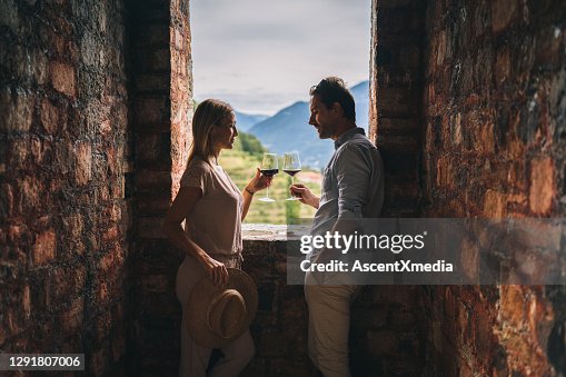 Couple enjoy some red wine in ancient Italian castle Couple enjoy some red wine in ancient Italian castle