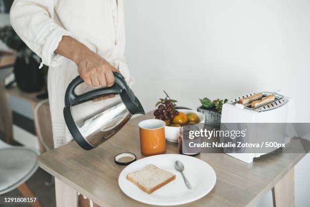 caucasian man preparing breakfast in bathrobe in hotel room,chiang mai,thailand - kettle stock pictures, royalty-free photos & images