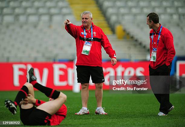 Wales head coach Warren Gatland speaks with his assistant coach Rob Howley during a Wales IRB Rugby World Cup 2011 captain's run at Eden Park on...