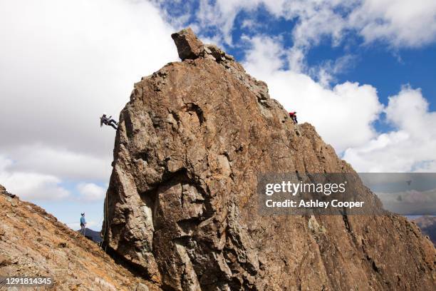 climbers abseiling from the summit of the inaccessible pinnacle onto sgurr dearg in the cuillin mountains, isle of skye, scotland, uk. - gabbro stock pictures, royalty-free photos & images