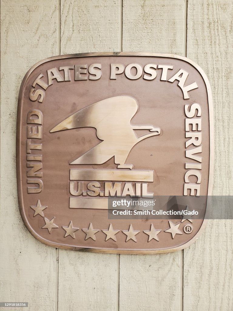 Postal Status Close-up shot of the United States Postal Service sign featuring an ...