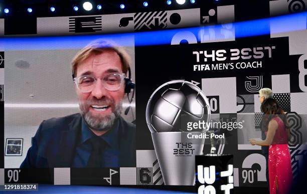 Juregen Klopp is seen giving a acceptance speech via video link after winning The Best FIFA Men's Coach award as Arsene Wenger and Reshmin Chowdhury...