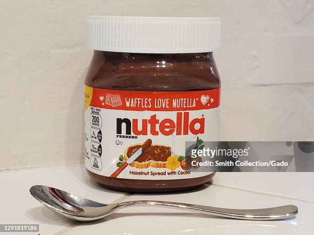 Close-up shot of a jar of Nutella with a spoon in front of it in San Ramon, California, December 7, 2020.
