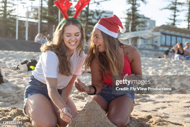 ビーチでクリスマスを祝う幸せな友人 - christmas australia ストックフォトと画像