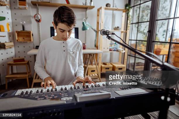 teenager boy playing synthesizer - keyboard musical instrument child stock pictures, royalty-free photos & images