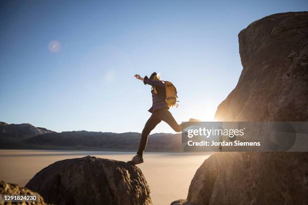 a woman hiking in the racetracks region of death valley - nevada nature stock pictures, royalty-free photos & images