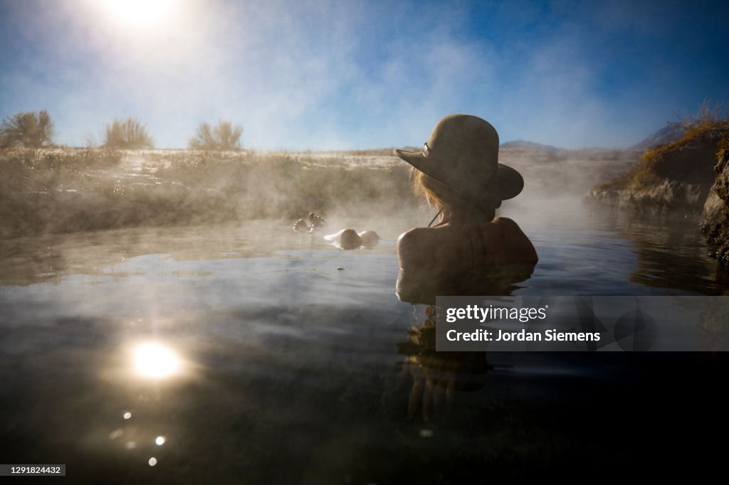 A woman soaking in hotsprings of the Eastern Sierras.