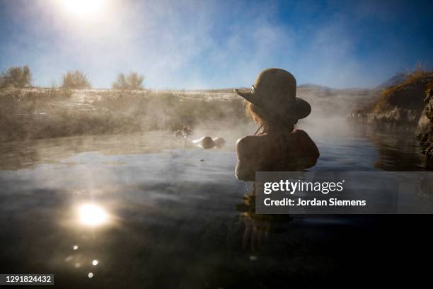 a woman soaking in hotsprings of the eastern sierras. - eastern usa stockfoto's en -beelden