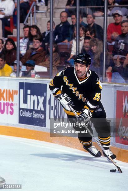 Bryan Trottier of the Pittsburgh Penguins skates with the puck during an NHL game circa 1993.