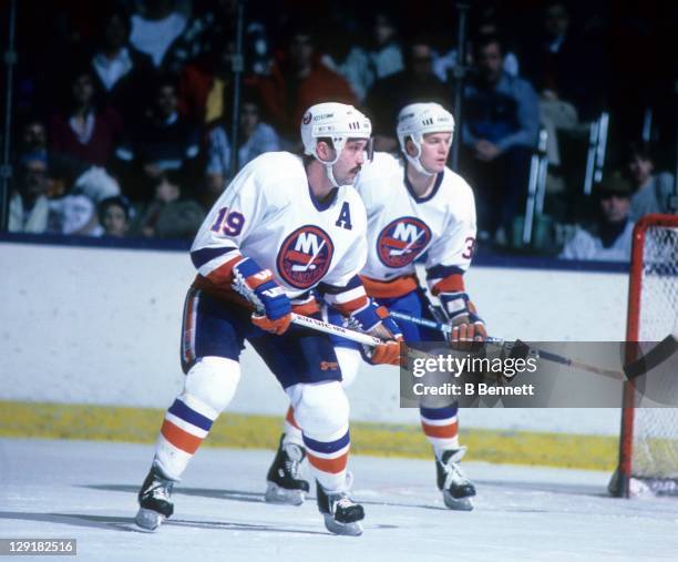 Bryan Trottier and Steve Konroyd of the New York Islanders defend the net during an NHL game in January, 1987 at the Nassau Coliseum in Uniondale,...