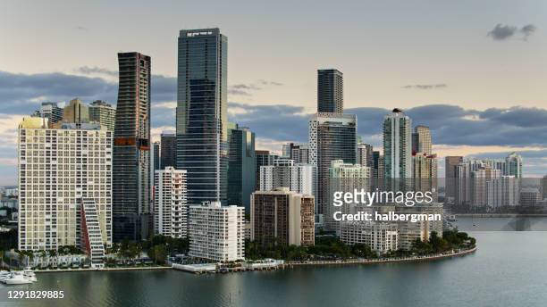 drone shot of sunlight glinting on miami towers - miami stock pictures, royalty-free photos & images