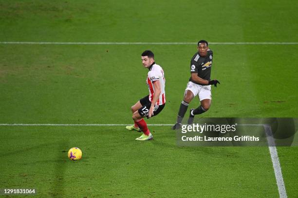 Anthony Martial of Manchester United scores their sides second goal past John Egan of Sheffield United during the Premier League match between...