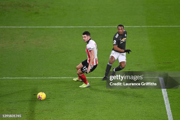 Anthony Martial of Manchester United scores their sides second goal past John Egan of Sheffield United during the Premier League match between...