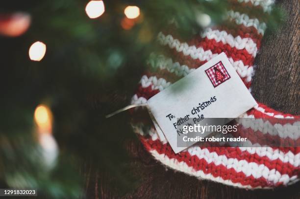 letter to father christmas on christmas stocking - child writing letter to santa stock pictures, royalty-free photos & images