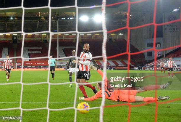 David McGoldrick of Sheffield United scores their sides first goal past Dean Henderson of Manchester United during the Premier League match between...