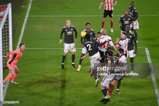David McGoldrick of Sheffield United scores their sides second goal past Dean Henderson of Manchester United as he is challenged by Victor Lindelof...