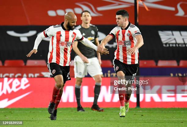 David McGoldrick of Sheffield United is congratulated by team mate John Egan after scoring their sides second goal during the Premier League match...