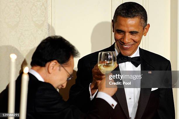 President Barack Obama and South Korean President Lee Myung-bak toast each other during a State Dinner in the East Room of the White House October...