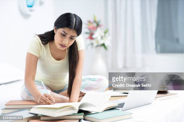 beautiful young woman study at home - stock photo - test preparation stock pictures, royalty-free photos & images