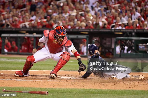Jerry Hairston Jr. #15 of the Milwaukee Brewers slides safely into home plate as he scores on a RBI single by Yuniesky Betancourt in the top of the...