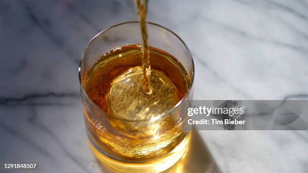 classic prohibition manhattan cocktail in old fashioned rocks glass being stirred - rye - grain stock pictures, royalty-free photos & images