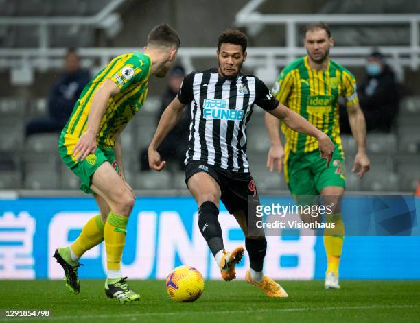 Joelinton of Newcastle United in action with Dara O'Shea and Branislav Ivanovic of West Bromwich Albion during the Premier League match between...