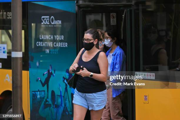 Passengers wearing masks leave a B Line bus at Wynyard on December 18, 2020 in Sydney, Australia. A cluster of Covid-19 cases on the northern beaches...
