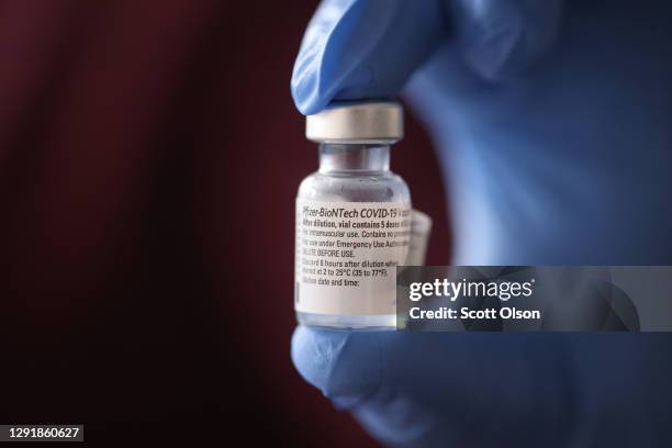 Nurse shows a container of Pfizer-BioNTech COVID-19 vaccine after it was used to vaccinate the first five staff members at Roseland Community...