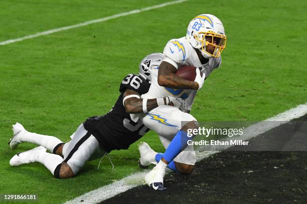 Wide receiver Tyron Johnson of the Los Angeles Chargers catches a touchdown pass as cornerback Daryl Worley of the Las Vegas Raiders defends during...