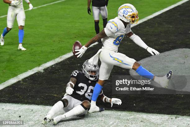 Wide receiver Tyron Johnson of the Los Angeles Chargers celebrates scoring a touchdown as cornerback Daryl Worley of the Las Vegas Raiders looks on...