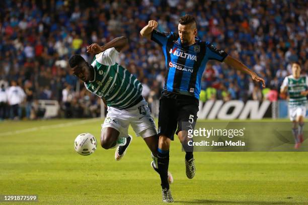 Jorge Djaniny Tavares of Santos fights for the ball with Yasser Corona of Queretaro during the final match of the 2015 Clausura Tournament between...