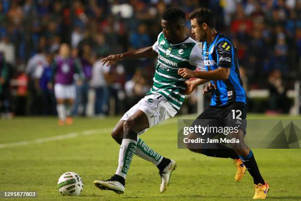 Jorge Djaniny Tavares of Santos fights for the ball with Jonathan Bornstein of Queretaro during the final match of the 2015 Clausura Tournament...