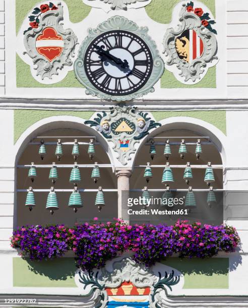 flowers and bells with clock on town hall, gmunden, salzkammergut, upper austria, austria - gmunden austria stock pictures, royalty-free photos & images