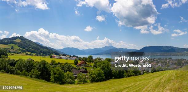 austria, upper austria, weyregg am attersee, panorama of rural town on shore of lake atter in summer - attersee stock pictures, royalty-free photos & images
