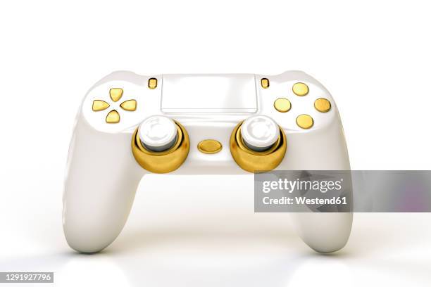 white and gold colored video game console - gaming controller fotografías e imágenes de stock