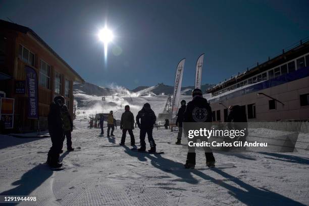 Silhouetted skiers receive snowboarding lessons at the Sierra Nevada Ski Resort on opening day on December 18, 2020 in Sierra Nevada, Spain. The...