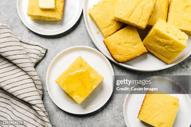 golden cornbread squares topped with butter or honey - cornbread stock pictures, royalty-free photos & images