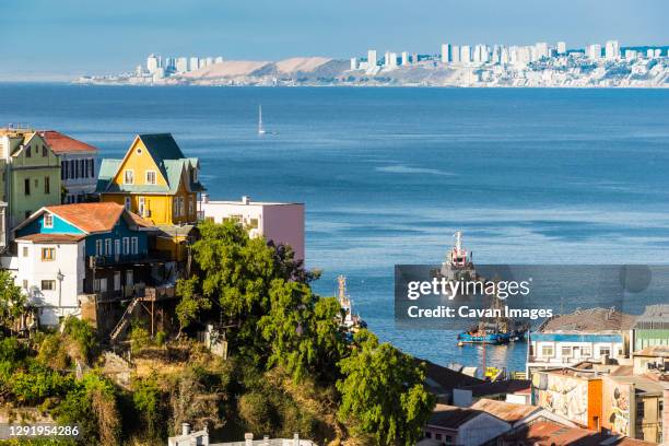 houses on a hill in valparaiso with vina del mar in the background, chile - valparaiso chile stock pictures, royalty-free photos & images