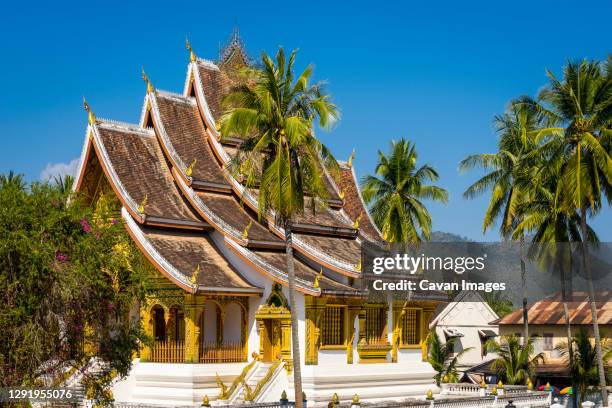 exterior of haw pha bang buddhist temple against clear blue sky, luang prabang, laos - laos stock pictures, royalty-free photos & images