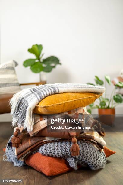 stack of fall pillows with blankets - autumn living room stock pictures, royalty-free photos & images