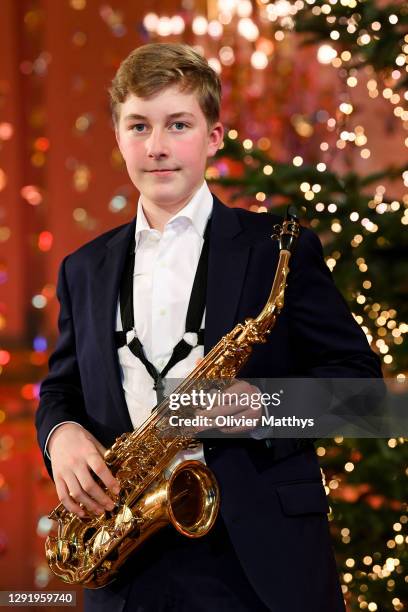 Prince Emmanuel of Belgium plays the saxophone during the Christmas concert with the Scala Choirat the Royal Palace on December 17, 2020 in Brussels,...