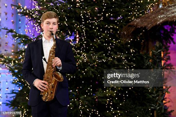 Prince Emmanuel of Belgium plays the saxophone during the Christmas concert with the Scala Choir at the Royal Palace on December 17, 2020 in...