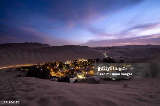 oasis huacachina at dusk, very close from ica, among sand dunes - huacachina stock pictures, royalty-free photos & images